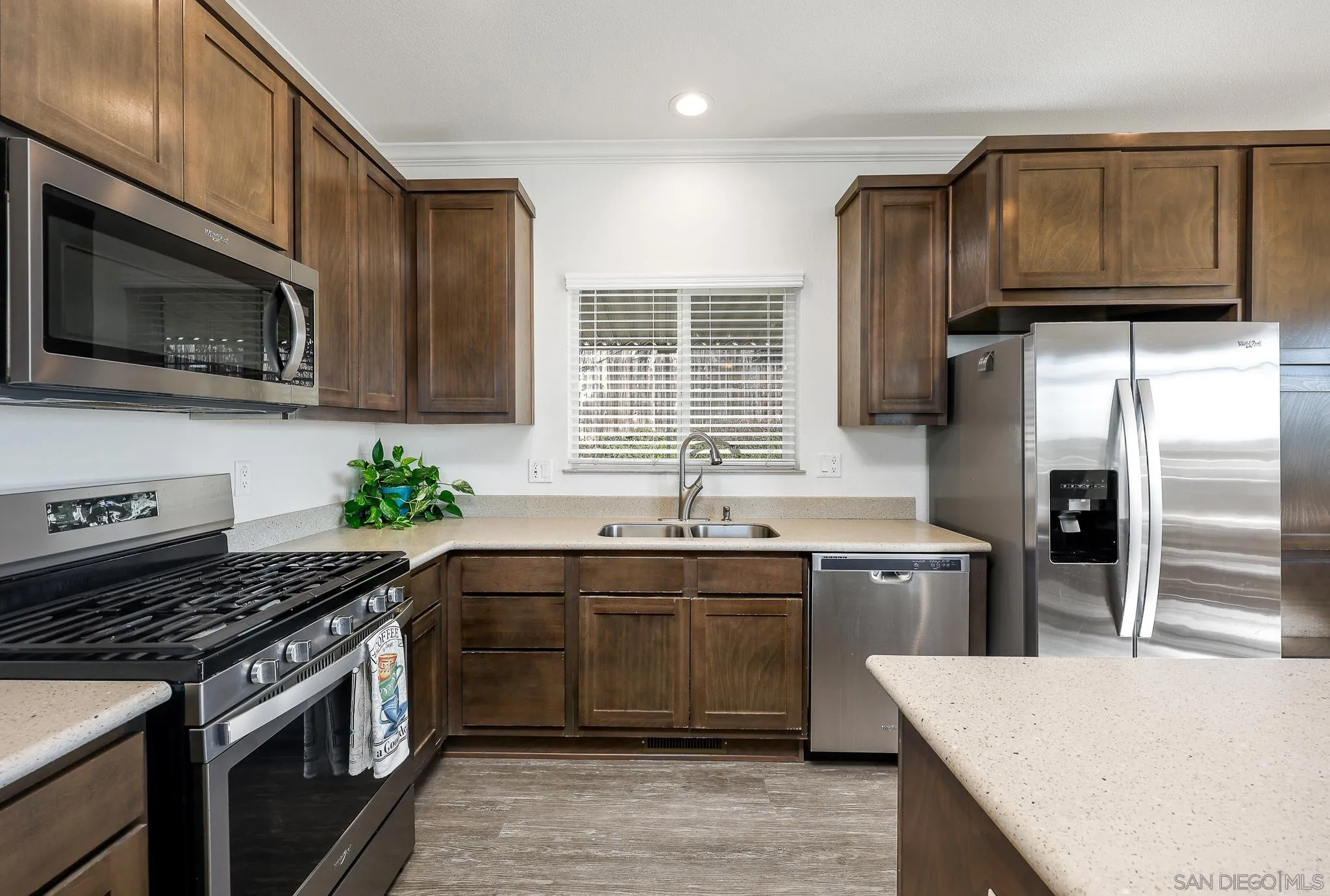 250 La Cresta Heights Road, Unit SPC 12 El Cajon, CA 92021 - Photo 15 of 36 a kitchen with stainless steel appliances wooden cabinets granite counter tops a stove a sink a refrigerator and cabinets