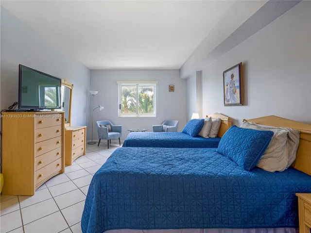 a bedroom with a bed and a dresser in it