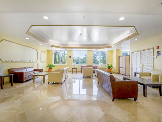 a living room with lots of furniture and a large window