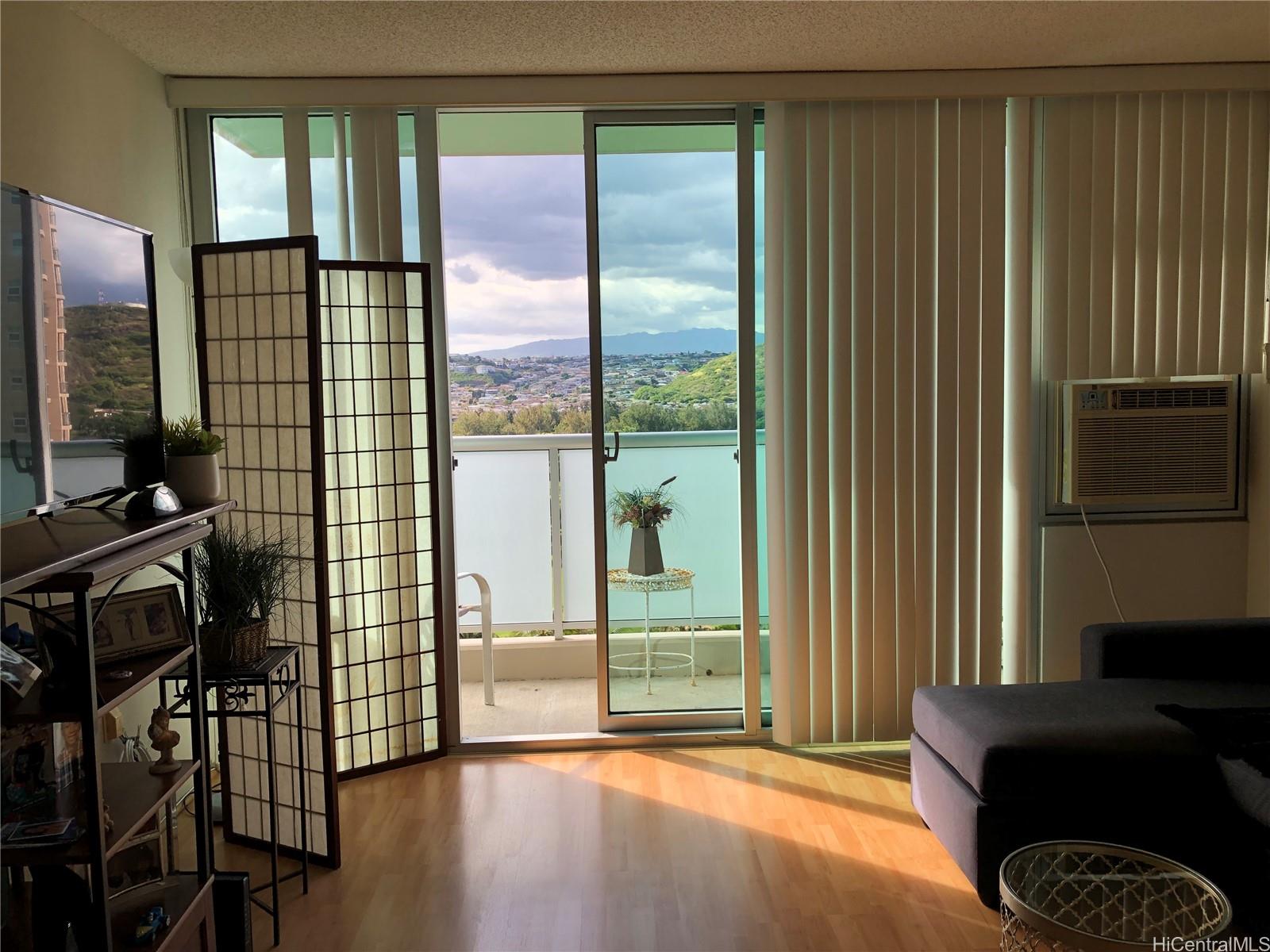 a view of a livingroom with furniture and floor to ceiling window