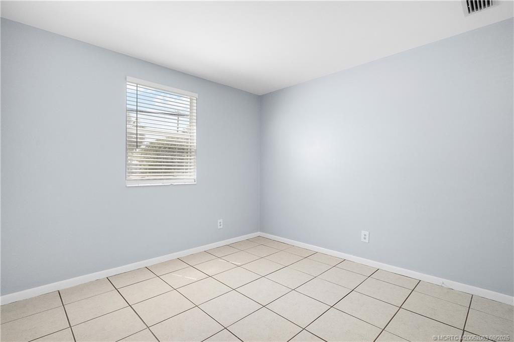 333 Southeast Martin Avenue, Unit 1A Stuart, FL 34996 - Photo 12 of 23 a view of an empty room and window