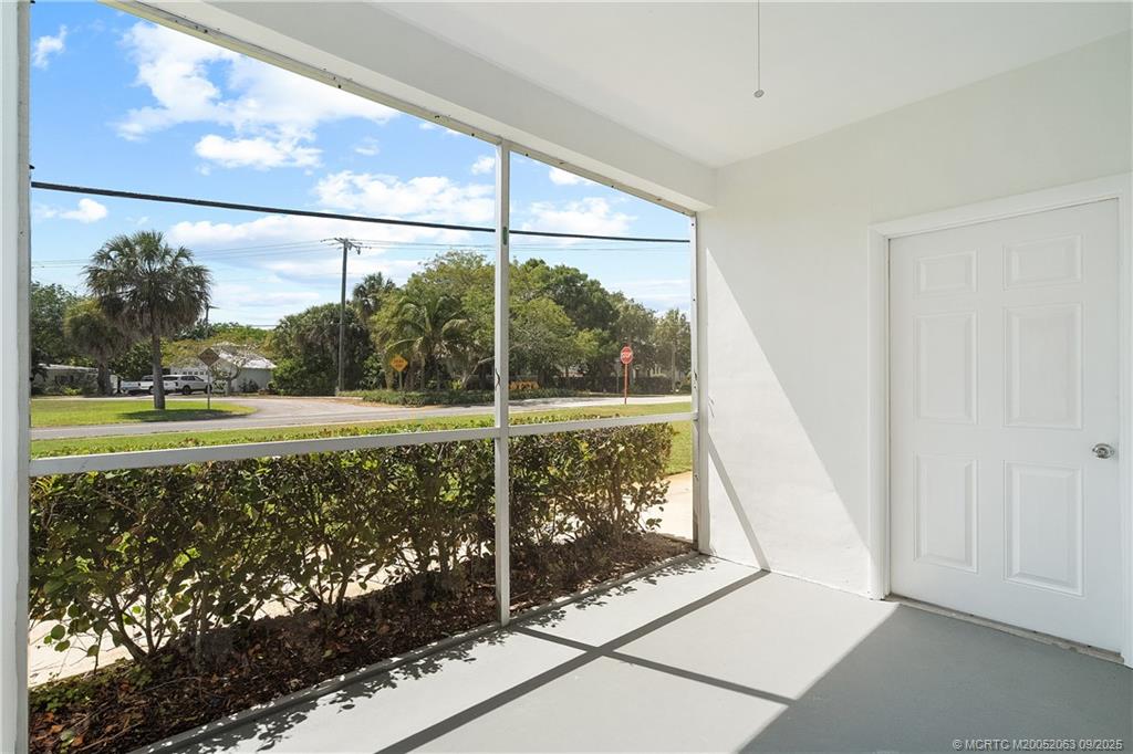 333 Southeast Martin Avenue, Unit 1A Stuart, FL 34996 - Photo 17 of 23 a view of a glass door and a yard