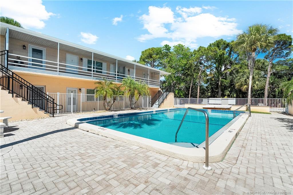 333 Southeast Martin Avenue, Unit 1A Stuart, FL 34996 - Photo 19 of 23 a view of a tennis ground with large trees