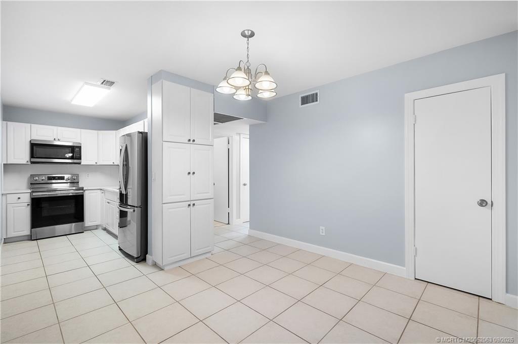 333 Southeast Martin Avenue, Unit 1A Stuart, FL 34996 - Photo 6 of 23 a view of a kitchen with refrigerator and an oven