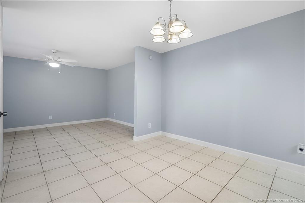 333 Southeast Martin Avenue, Unit 1A Stuart, FL 34996 - Photo 7 of 23 an empty room with a chandelier fan