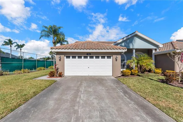 a view of a house with a yard and garage