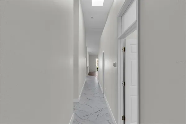a view of a hallway with wooden shelves