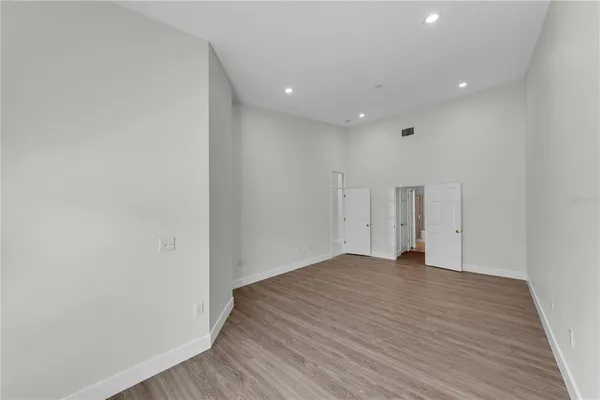 a view of an empty room with wooden floor