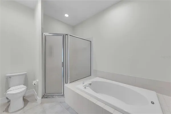 a bathroom with a toilet and bathtub