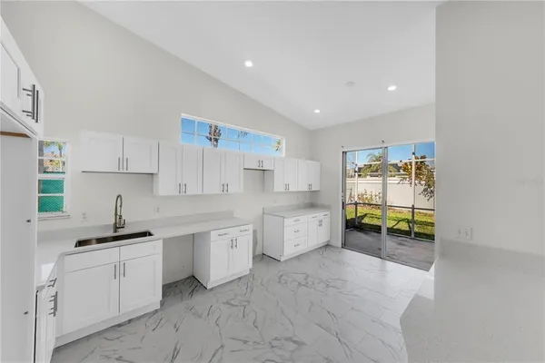 a kitchen with sink and cabinets