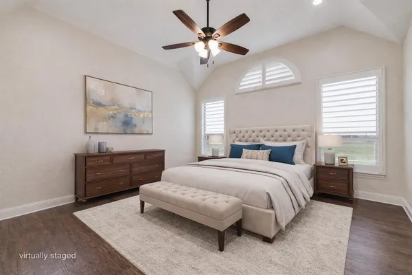 a spacious bedroom with a bed and window