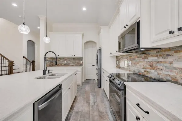 a kitchen with a sink stove and cabinets