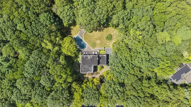 an aerial view of a house with a yard