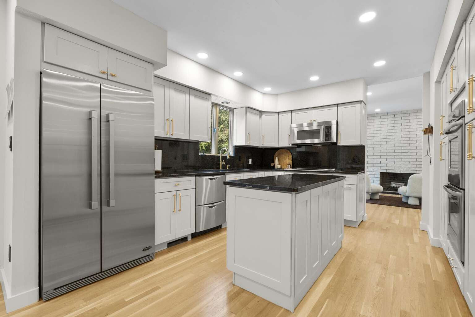 40 Old Quarry Road Woodbridge, CT 06525 - Photo 16 of 39 a kitchen with kitchen island granite countertop a refrigerator a sink and wooden cabinets