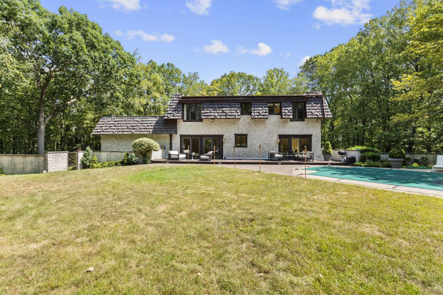 40 Old Quarry Road Woodbridge, CT 06525 - Photo 38 of 39 a front view of a house with a yard and large trees