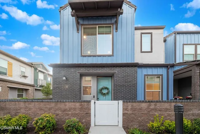 a view of a brick house with large windows
