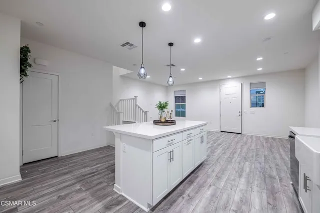 a kitchen with white cabinets and appliances