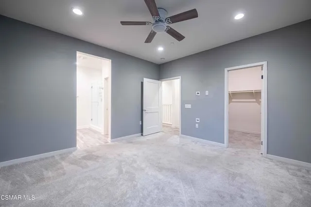 a spacious bathroom with a double vanity sink and mirror