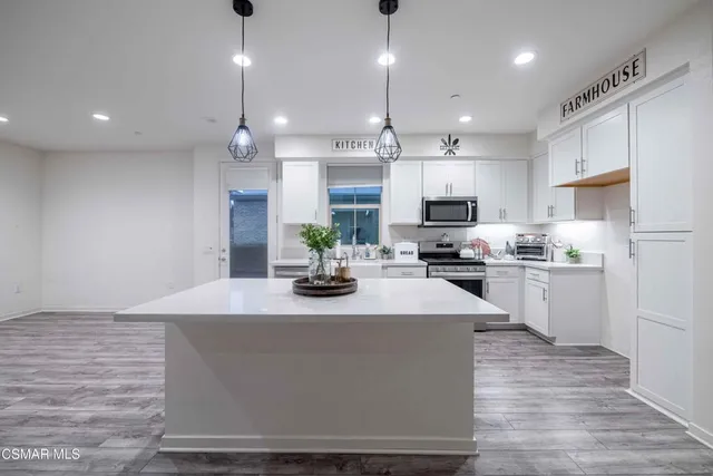 a kitchen with a stove a sink and a refrigerator