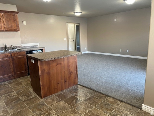 917 South Main Street, Unit H Layton, UT 84041 - Photo 19 of 19 Kitchen with dark countertops, dark stone finish floors, dark colored carpet, open floor plan, and a kitchen island
