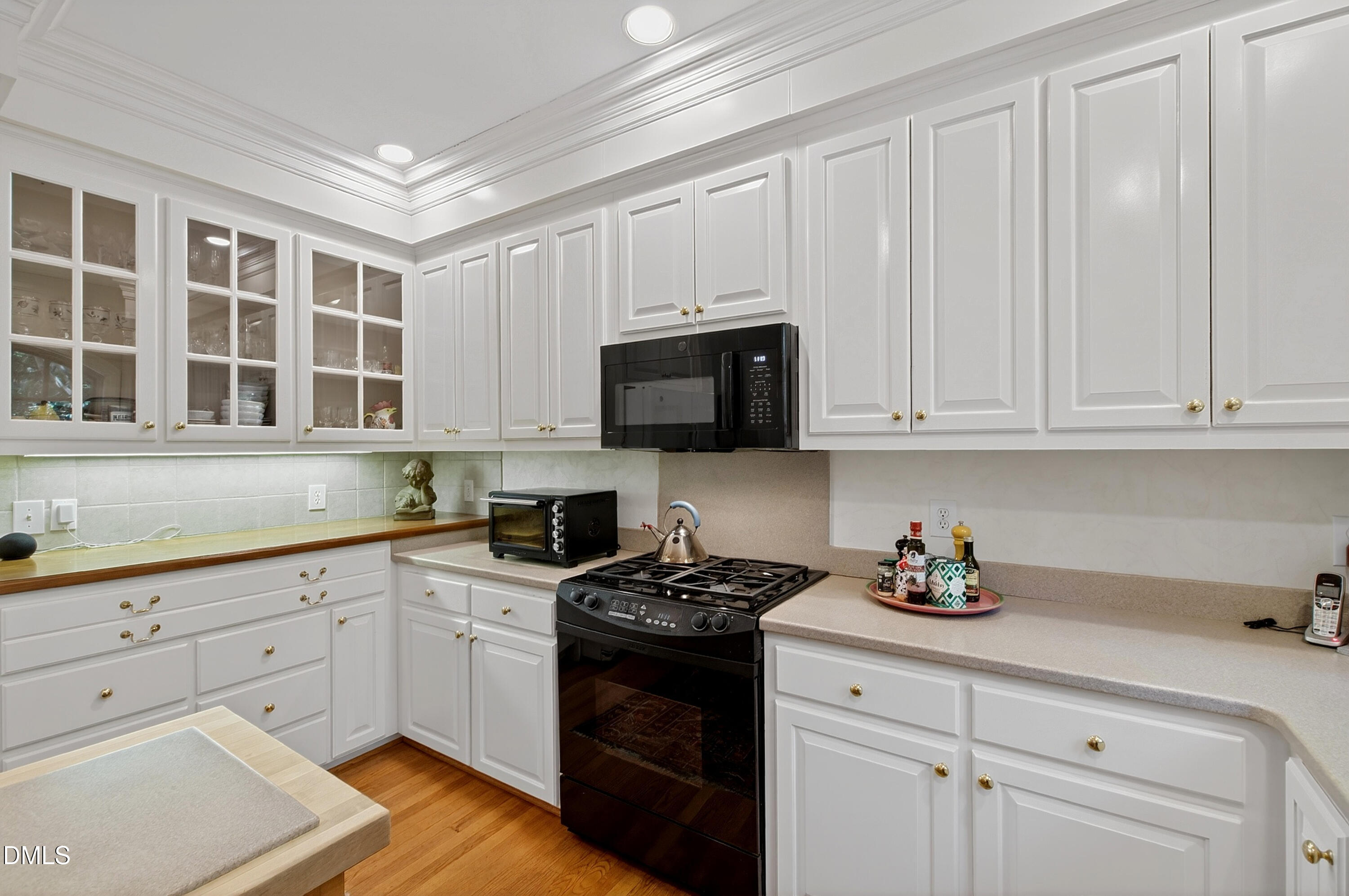 3708 Lubbock Drive Raleigh, NC 27612 - Photo 13 of 64 a kitchen with granite countertop white cabinets stainless steel appliances and sink