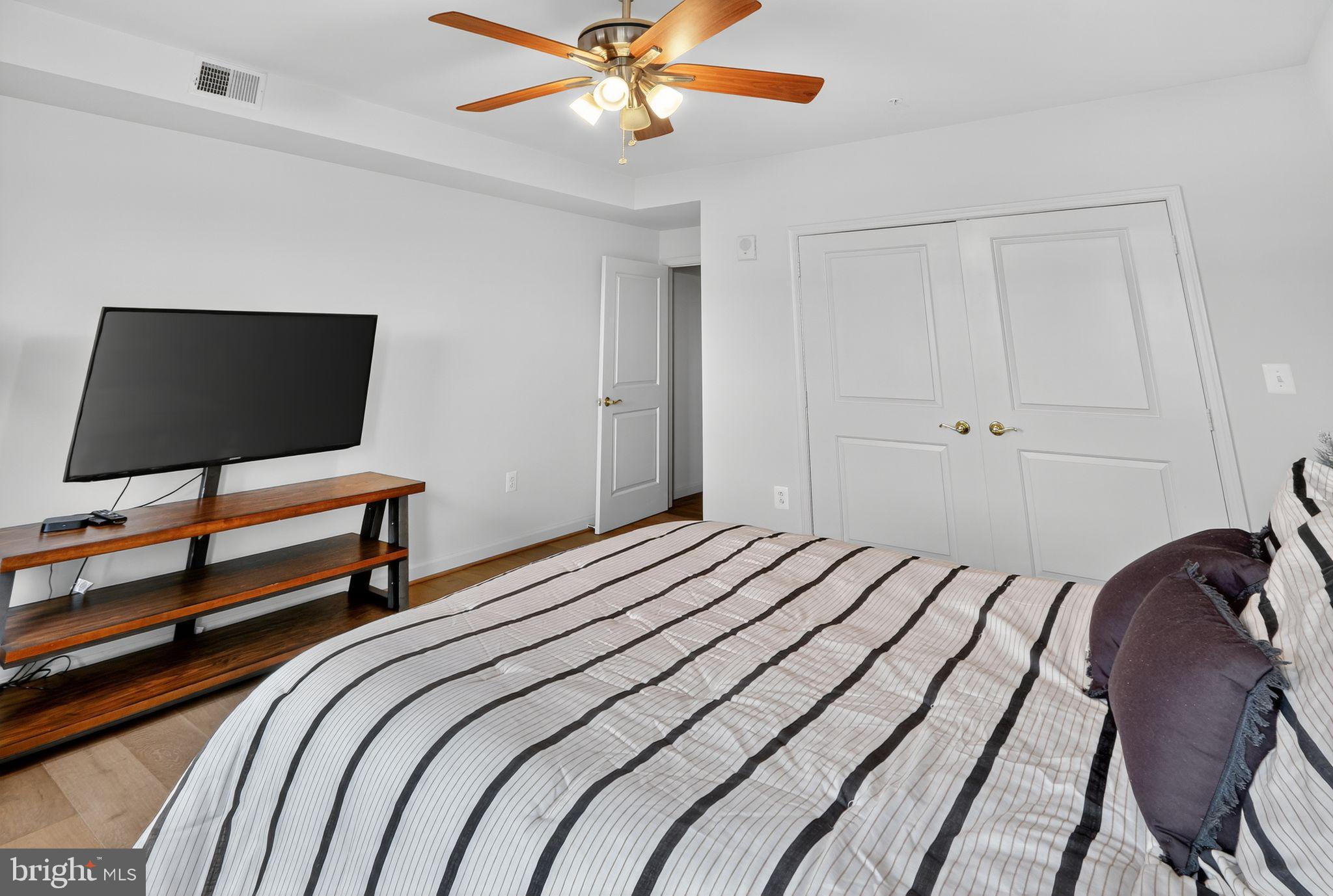 485 Harbor Side Street, Unit 407 Woodbridge, VA 22191 - Photo 19 of 47 Modern bedroom with sleek design elements.