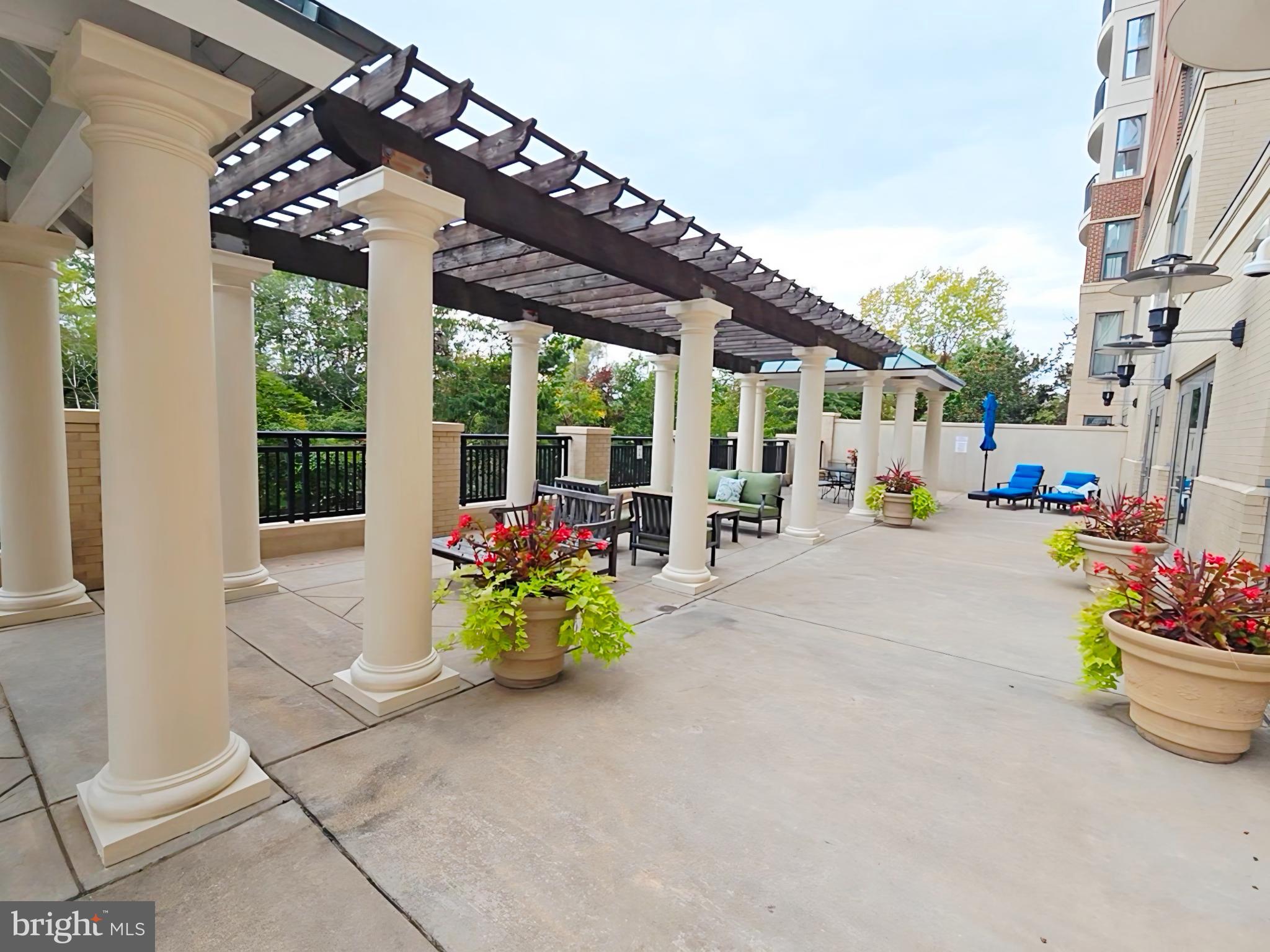 485 Harbor Side Street, Unit 407 Woodbridge, VA 22191 - Photo 31 of 47 Elegant outdoor terrace with lush greenery.