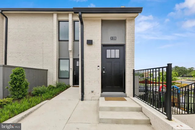 a view of a house with wooden fence