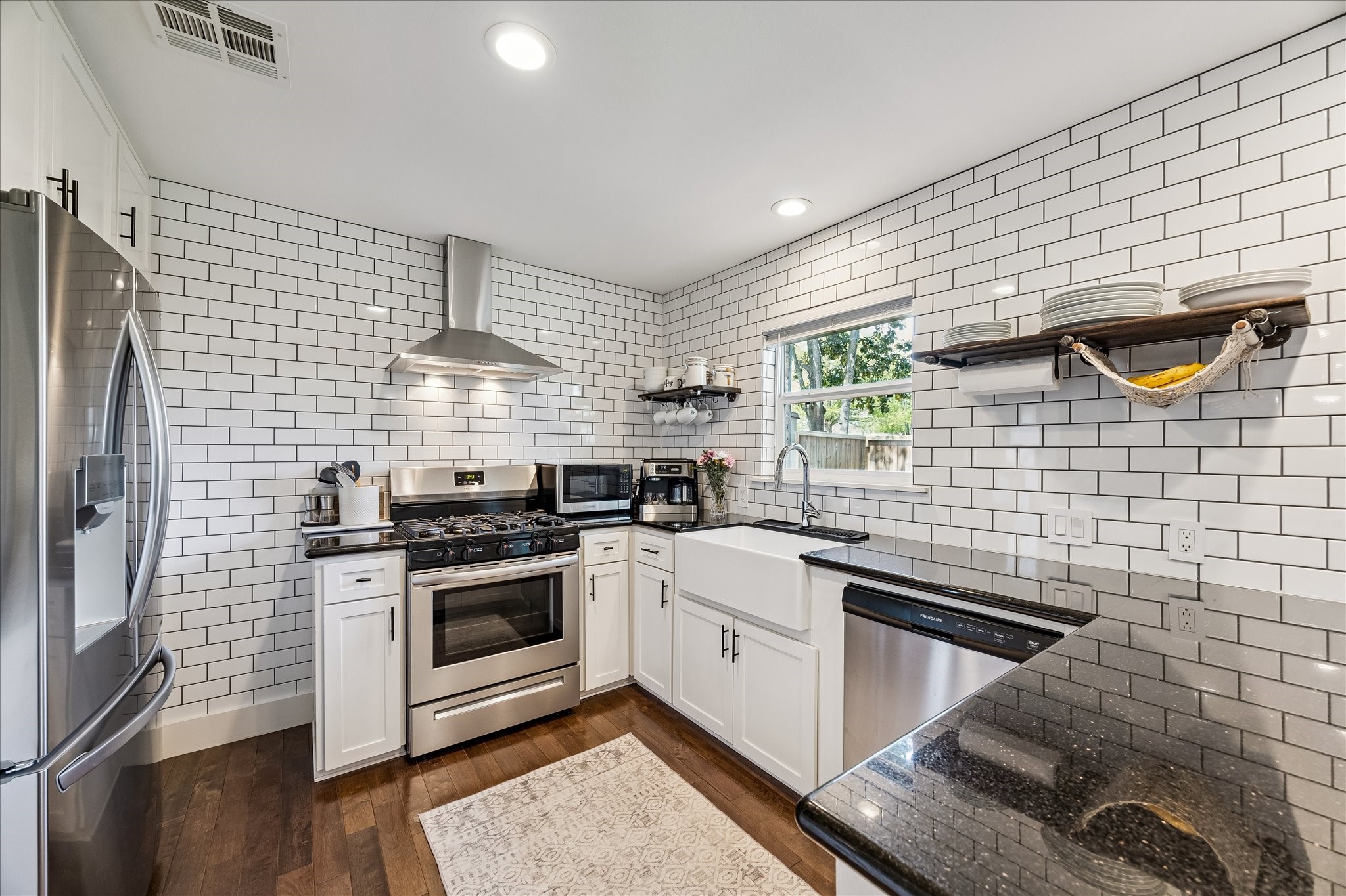 2203 Lamonte Lane Houston, TX 77018 - Photo 6 of 25 a kitchen with stainless steel appliances a stove a sink a chimney and cabinets