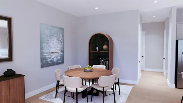 a view of a dining room with furniture and wooden floor
