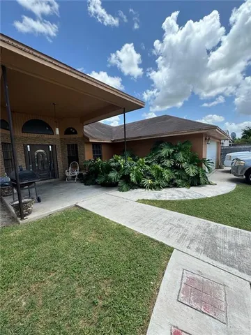 a view of a patio with a table and chairs under an umbrella