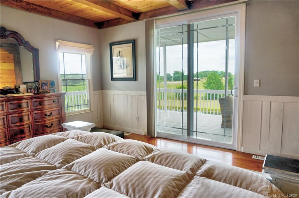 585 Christopher Road Campobello, SC 29322 - Photo 22 of 43 a bedroom with furniture and large windows
