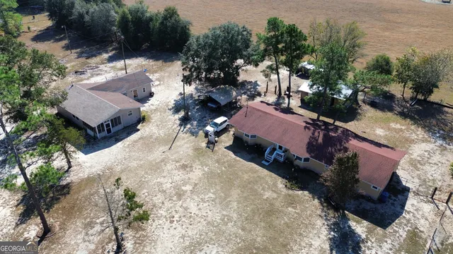 an aerial view of a house with a yard