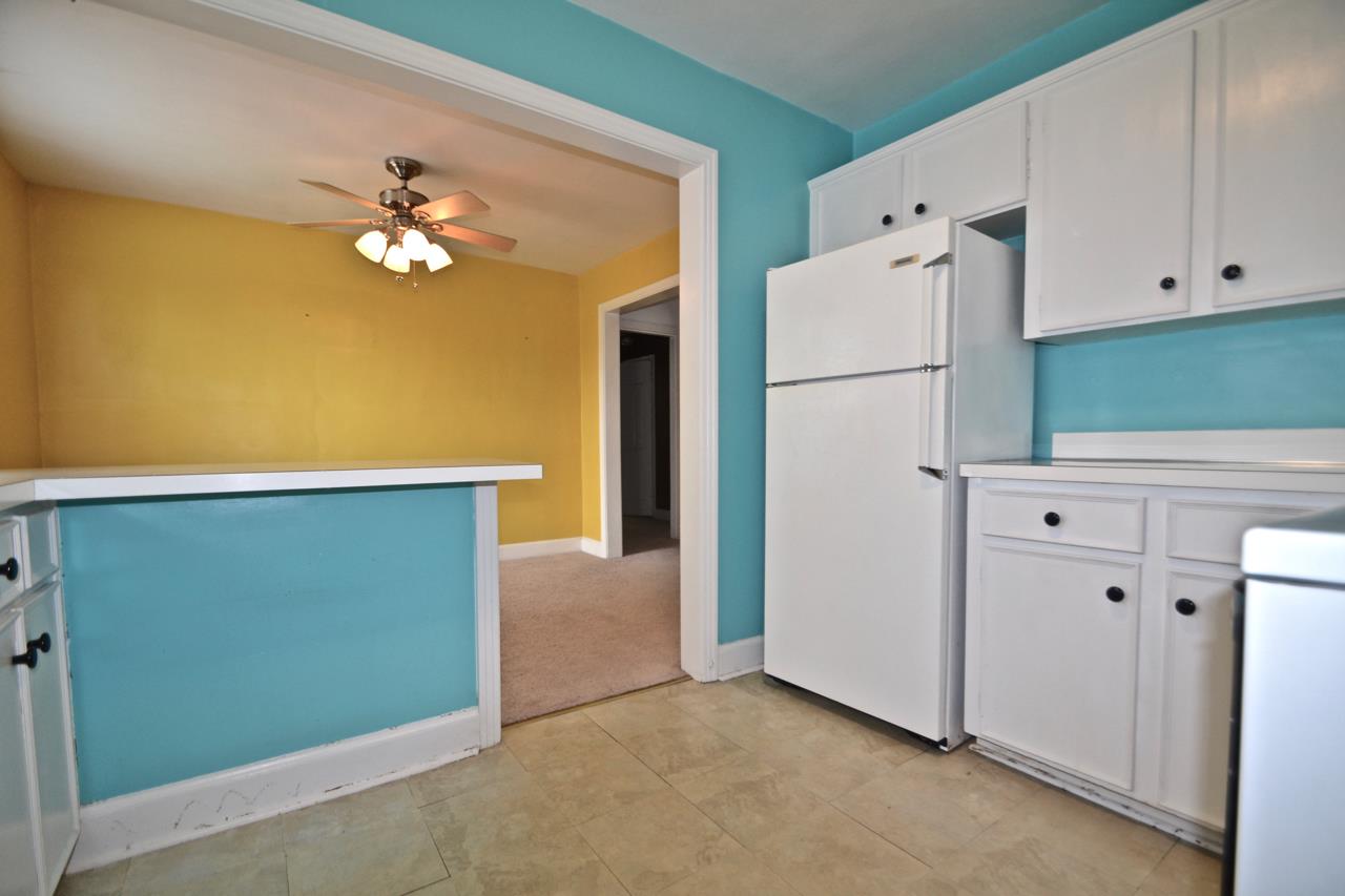 207 Cherokee Road Nashville, TN 37205 - Photo 17 of 24 a view of kitchen with white cabinets and refrigerator