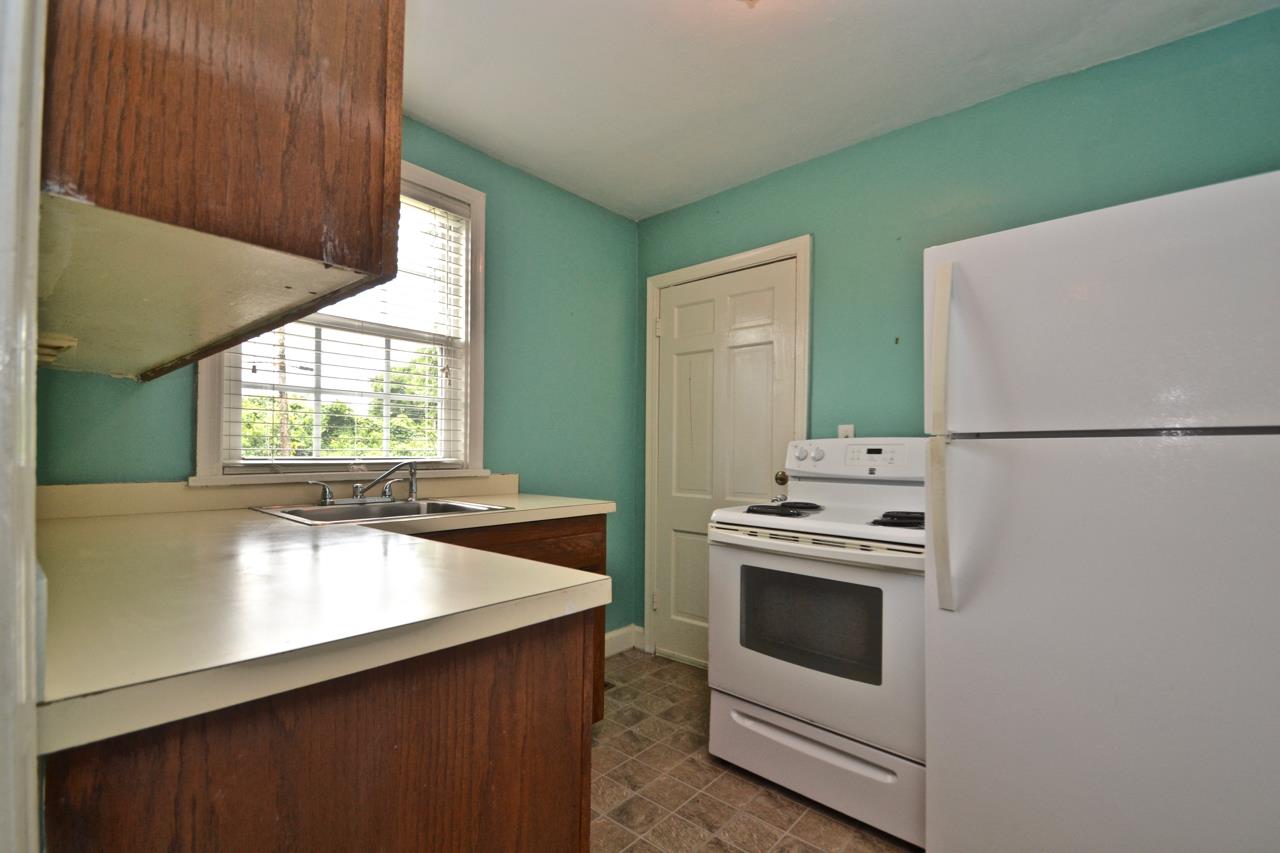 207 Cherokee Road Nashville, TN 37205 - Photo 6 of 24 a kitchen with a stove and a refrigerator