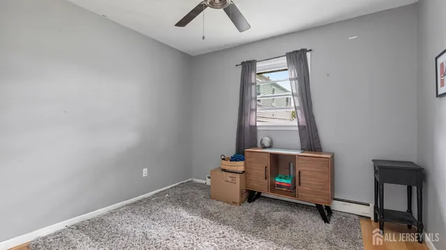 a view of a livingroom with wooden floor and a ceiling fan