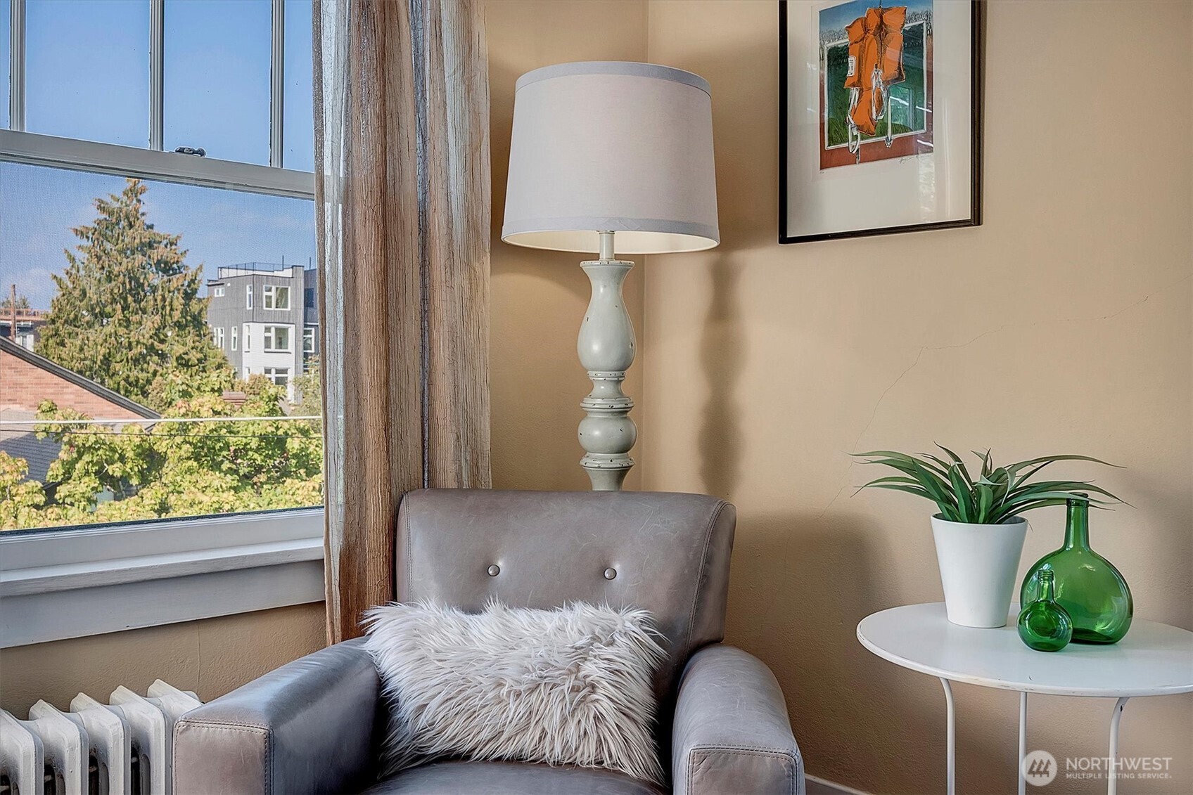 1605 East Olive Street, Unit 303 Seattle, WA 98122 - Photo 11 of 36 a bedroom with furniture and a potted plant