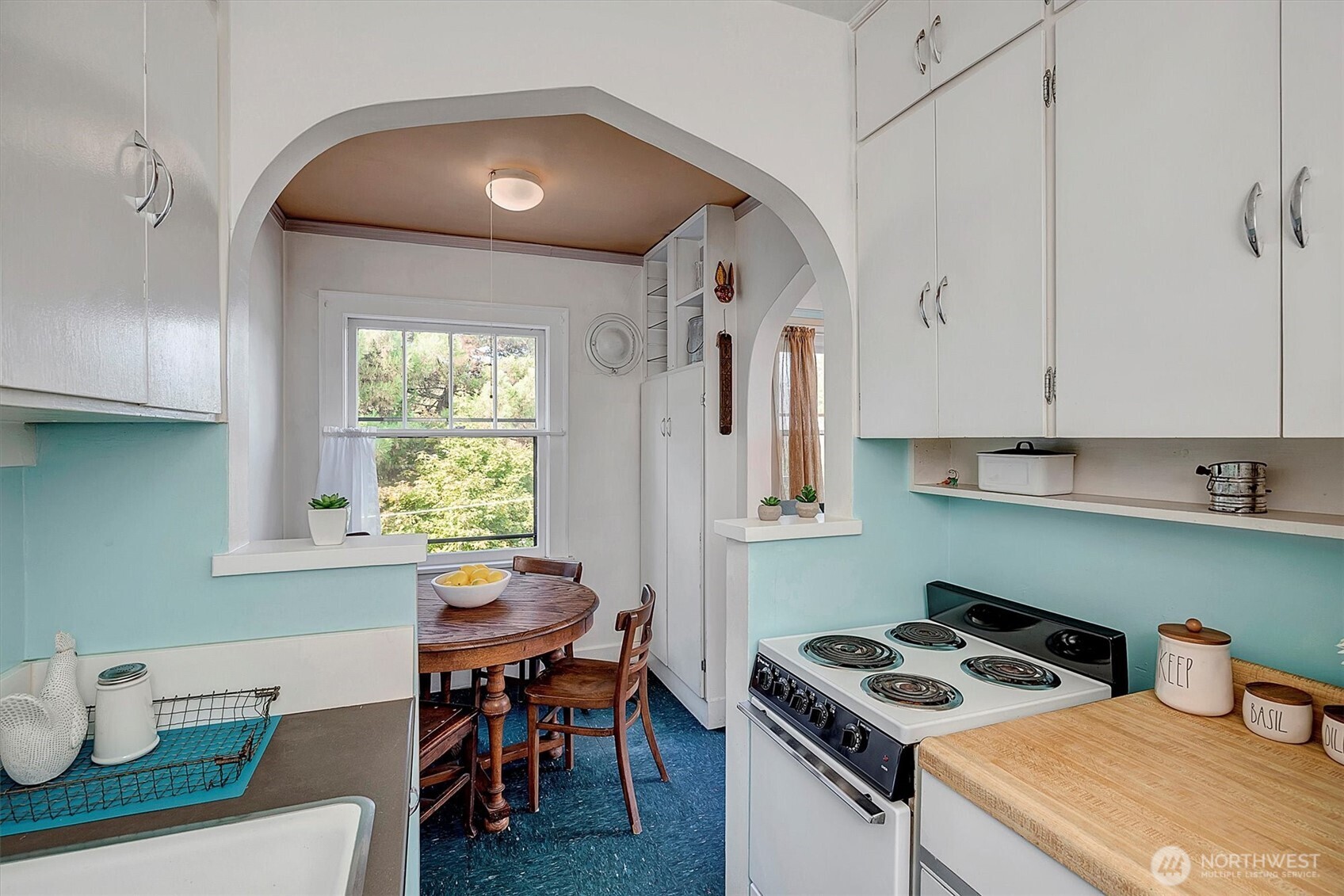 1605 East Olive Street, Unit 303 Seattle, WA 98122 - Photo 15 of 36 a kitchen that has a cabinets and a stove
