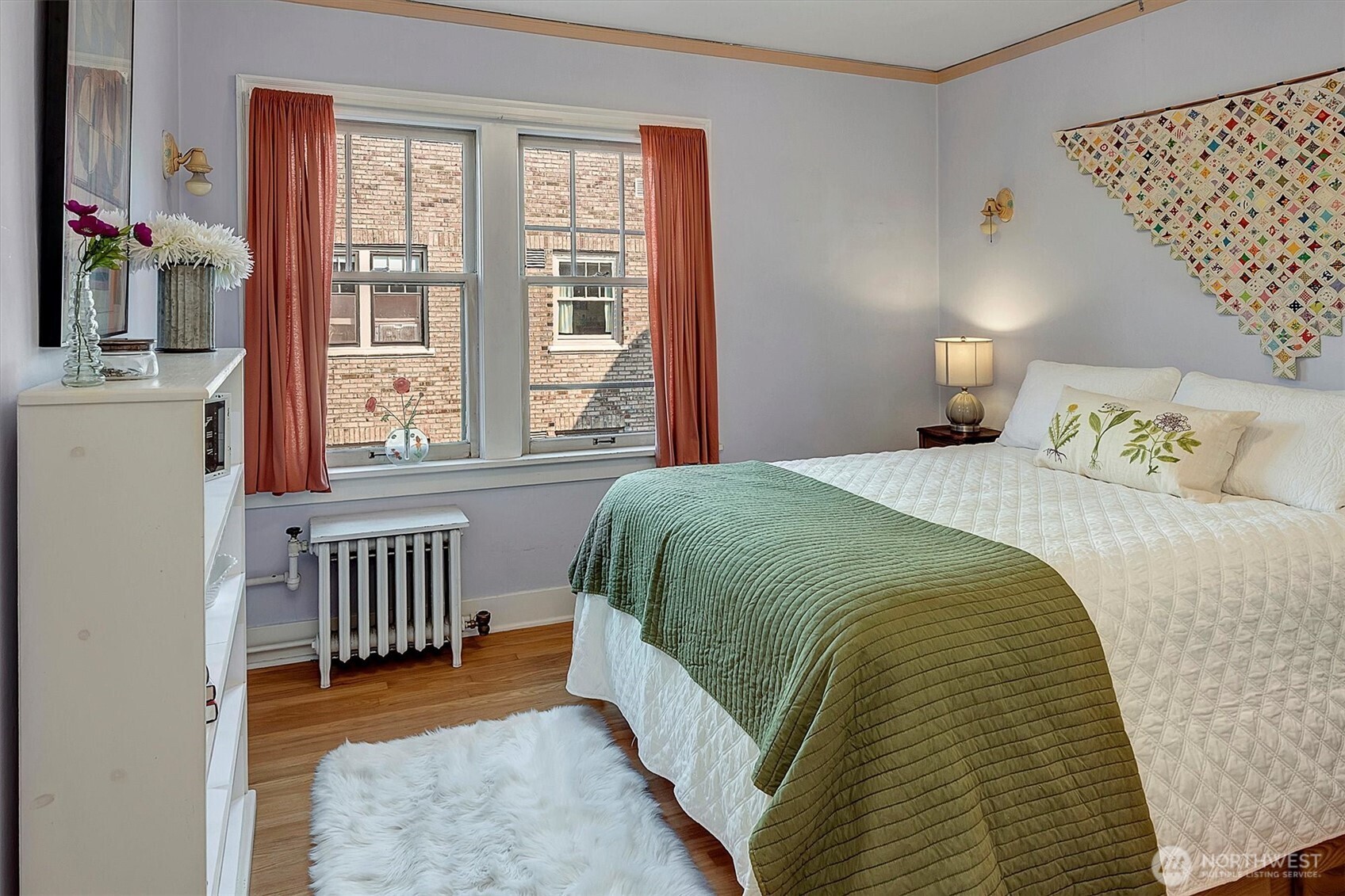 1605 East Olive Street, Unit 303 Seattle, WA 98122 - Photo 19 of 36 a bedroom with a bed and a window