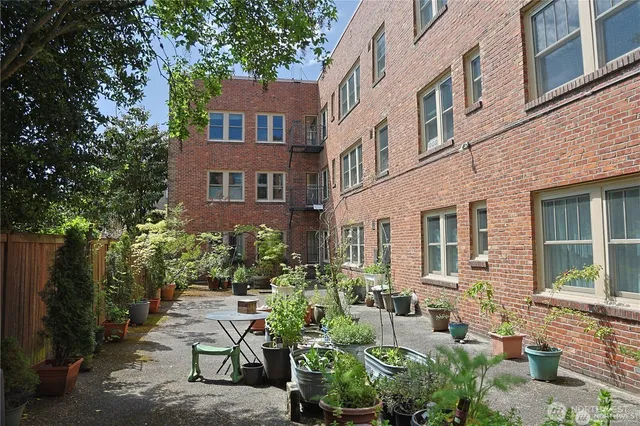 a room with lots of wooden furniture and a view of living room