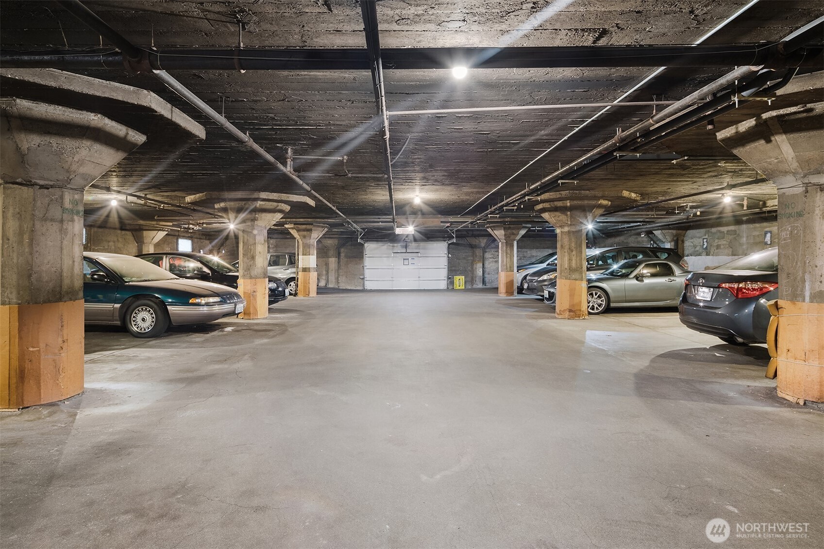 1605 East Olive Street, Unit 303 Seattle, WA 98122 - Photo 27 of 36 a view of parking garage with cars