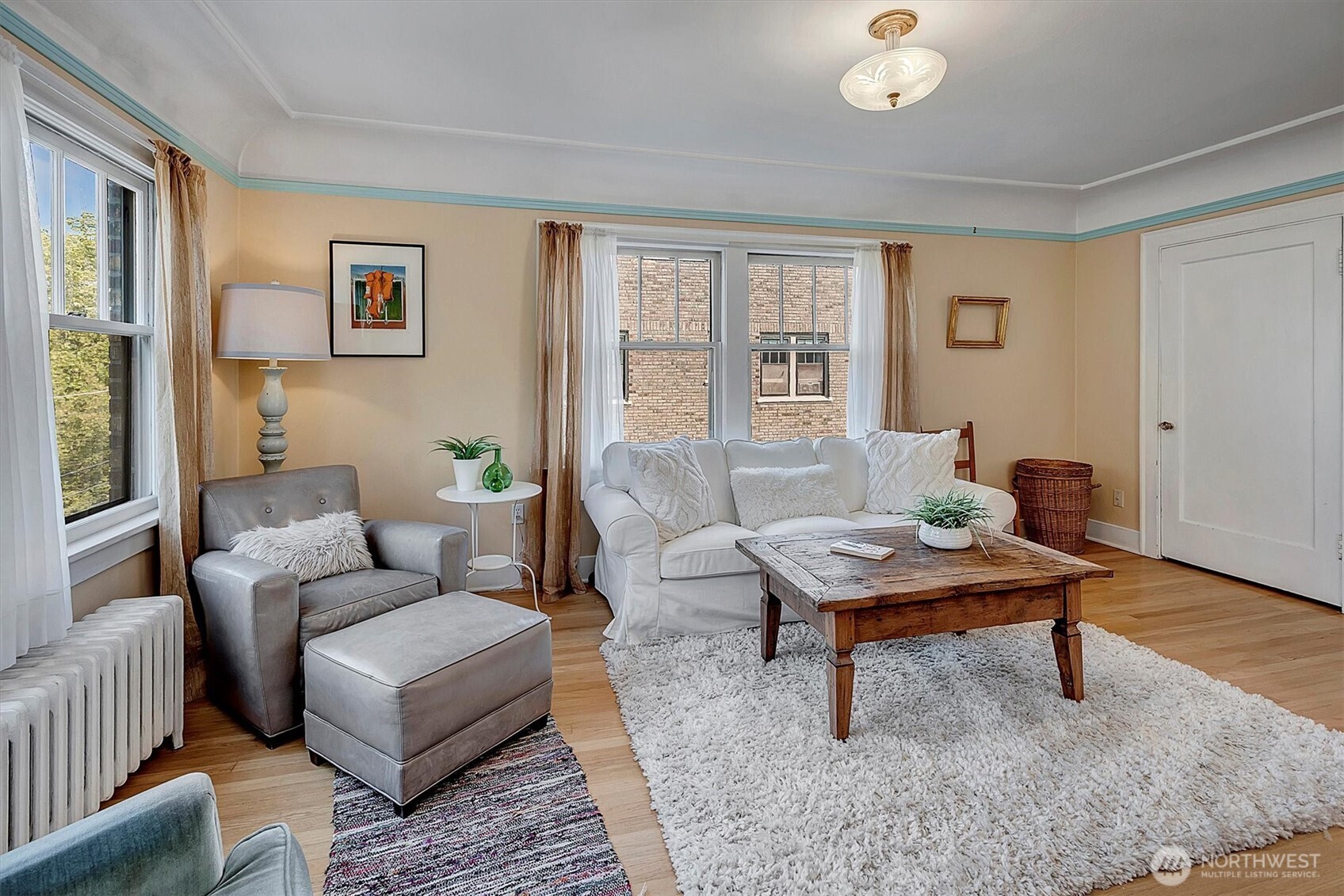 1605 East Olive Street, Unit 303 Seattle, WA 98122 - Photo 7 of 36 a living room with furniture and wooden floor