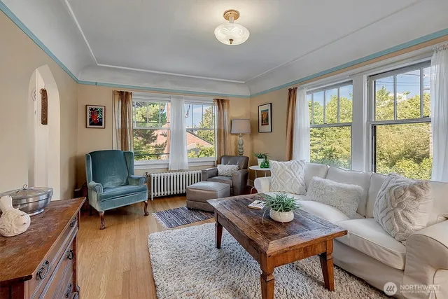 a living room with furniture and a wooden floor