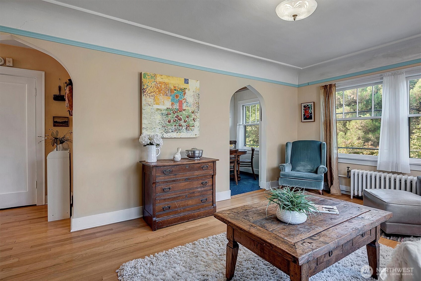 1605 East Olive Street, Unit 303 Seattle, WA 98122 - Photo 10 of 36 a living room with furniture and a wooden floor
