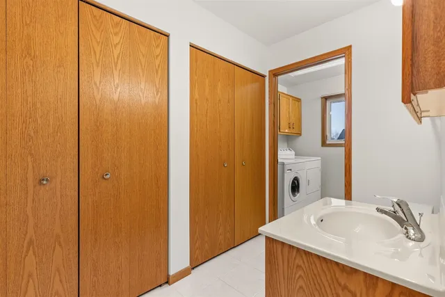 a bathroom with a tub sink and mirror