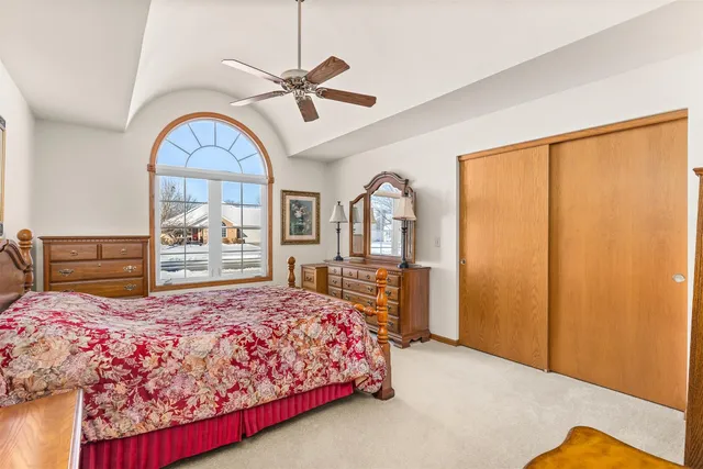 a bedroom with a large bed and a chandelier