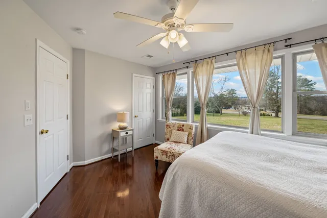 a spacious bedroom with a large bed and a large window with outer view