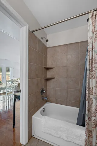 a bathroom with a bathtub and a shower