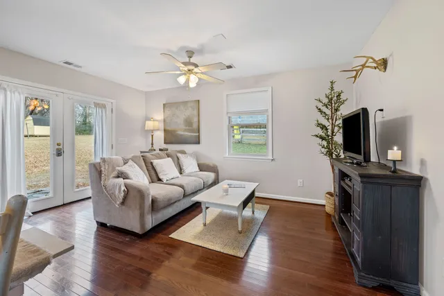 a living room with furniture a fireplace and a flat screen tv