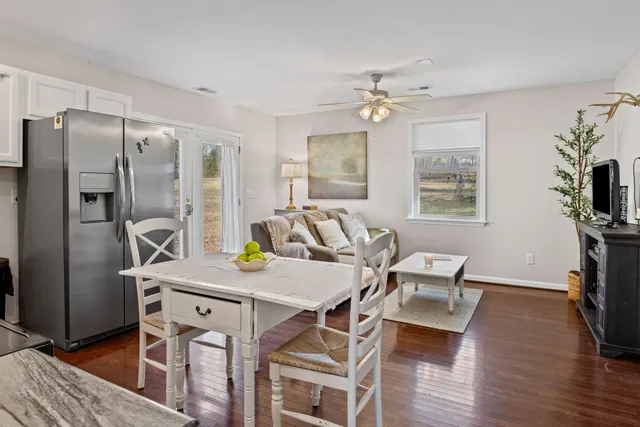 a view of a dining room with furniture a chandelier and wooden floor